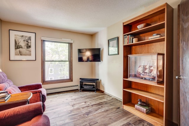 3020 Saint Albans Mill Rd Unit 309, Minnetonka, MN 55305 - living area with a baseboard radiator, wood finished floors, and a textured ceiling