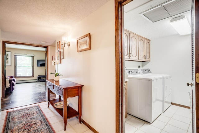 3020 Saint Albans Mill Rd Unit 309, Minnetonka, MN 55305 - laundry room with cabinet space, washer and clothes dryer, a textured ceiling, a baseboard heating unit, and baseboards