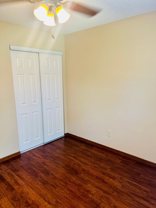 3333 Nevada Ave N Unit 3302, Crystal, MN 55427 - unfurnished bedroom with dark wood-type flooring, baseboards, a closet, and a ceiling fan