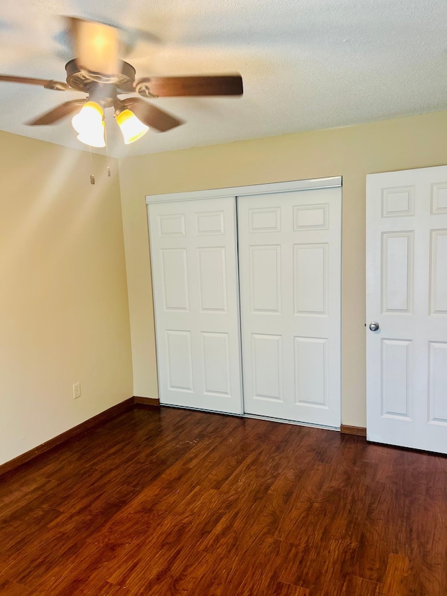 3333 Nevada Ave N Unit 3302, Crystal, MN 55427 - unfurnished bedroom with dark wood-style flooring, a closet, baseboards, and a ceiling fan