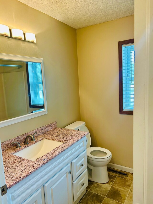 3333 Nevada Ave N Unit 3302, Crystal, MN 55427 - bathroom with vanity, toilet, a textured ceiling, and baseboards