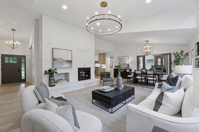 2324 Rivendell Ln, Minnetonka, MN 55305 - living area with a chandelier, a brick fireplace, light wood-style floors, recessed lighting, and high vaulted ceiling