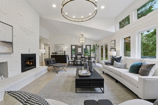 2324 Rivendell Ln, Minnetonka, MN 55305 - living room featuring a chandelier, a fireplace, wood finished floors, high vaulted ceiling, and recessed lighting