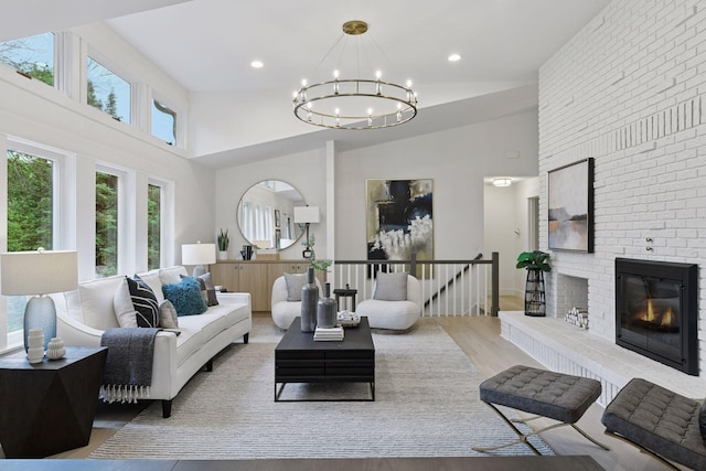 2324 Rivendell Ln, Minnetonka, MN 55305 - living area with a chandelier, wood finished floors, high vaulted ceiling, a brick fireplace, and recessed lighting