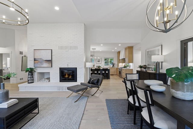 2324 Rivendell Ln, Minnetonka, MN 55305 - living room with a chandelier, light wood finished floors, a fireplace, and recessed lighting