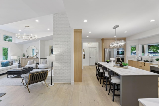 2324 Rivendell Ln, Minnetonka, MN 55305 - living room featuring a chandelier, plenty of natural light, light wood-type flooring, and recessed lighting
