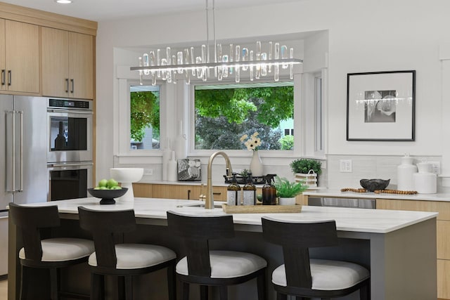2324 Rivendell Ln, Minnetonka, MN 55305 - kitchen with double oven, modern cabinets, backsplash, and a kitchen bar