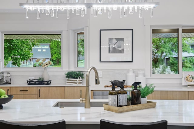 2324 Rivendell Ln, Minnetonka, MN 55305 - kitchen with modern cabinets, light stone counters, and backsplash