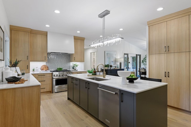 2324 Rivendell Ln, Minnetonka, MN 55305 - kitchen with stainless steel appliances, light wood finished floors, tasteful backsplash, light stone counters, and light brown cabinets