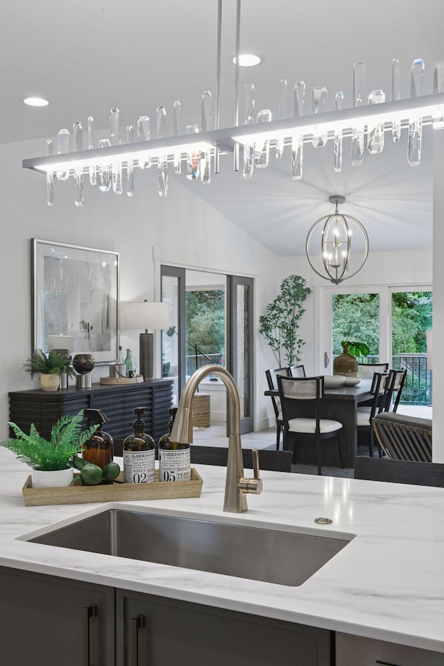2324 Rivendell Ln, Minnetonka, MN 55305 - kitchen featuring light stone countertops, plenty of natural light, and a chandelier