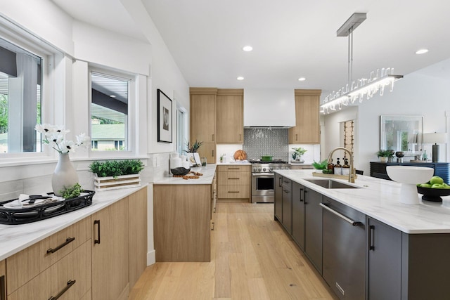 2324 Rivendell Ln, Minnetonka, MN 55305 - kitchen with appliances with stainless steel finishes, custom exhaust hood, light wood finished floors, light stone counters, and decorative backsplash
