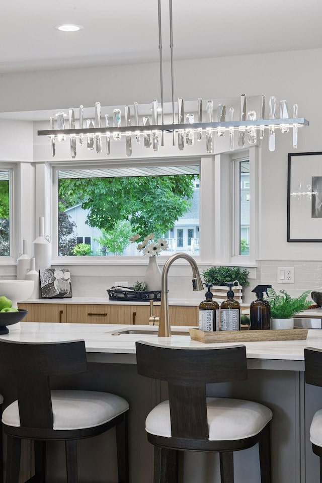 2324 Rivendell Ln, Minnetonka, MN 55305 - kitchen featuring light countertops, a breakfast bar, and healthy amount of natural light