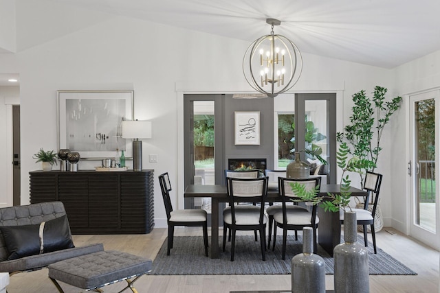 2324 Rivendell Ln, Minnetonka, MN 55305 - dining area featuring lofted ceiling, a chandelier, and wood finished floors
