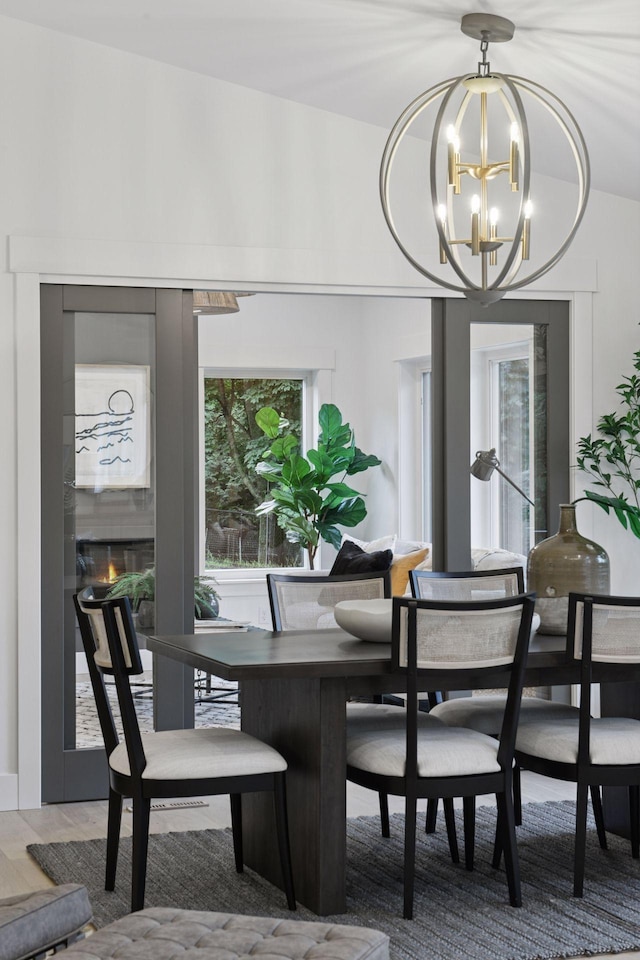 2324 Rivendell Ln, Minnetonka, MN 55305 - dining room with a chandelier and a glass covered fireplace