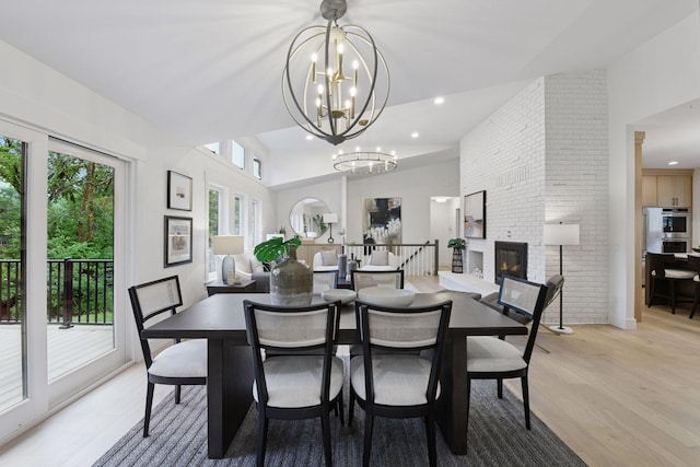2324 Rivendell Ln, Minnetonka, MN 55305 - dining room with light wood finished floors, a fireplace, a chandelier, and recessed lighting