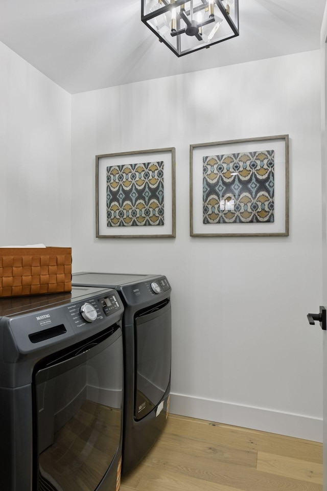 2324 Rivendell Ln, Minnetonka, MN 55305 - laundry room with separate washer and dryer, light wood-style floors, and a chandelier
