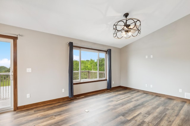 26884 709th St, Lake City, MN 55041 - spare room with a chandelier, wood finished floors, and lofted ceiling