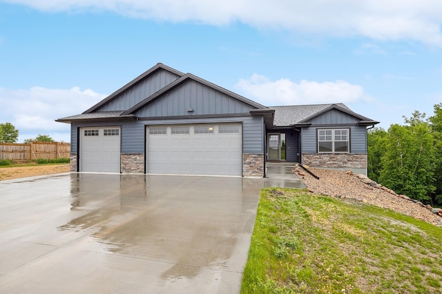 26884 709th St, Lake City, MN 55041 - view of front of property with a garage, driveway, board and batten siding, and stone siding