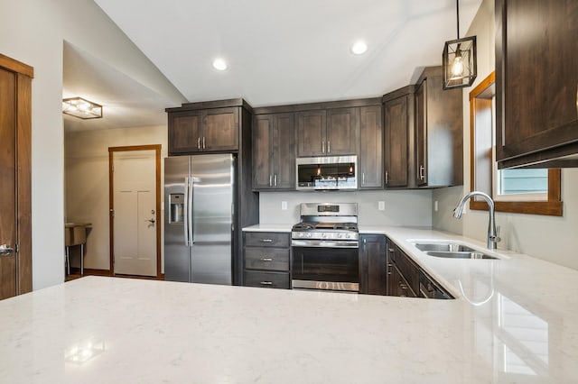 26884 709th St, Lake City, MN 55041 - kitchen with appliances with stainless steel finishes, vaulted ceiling, light stone counters, dark brown cabinetry, and decorative light fixtures