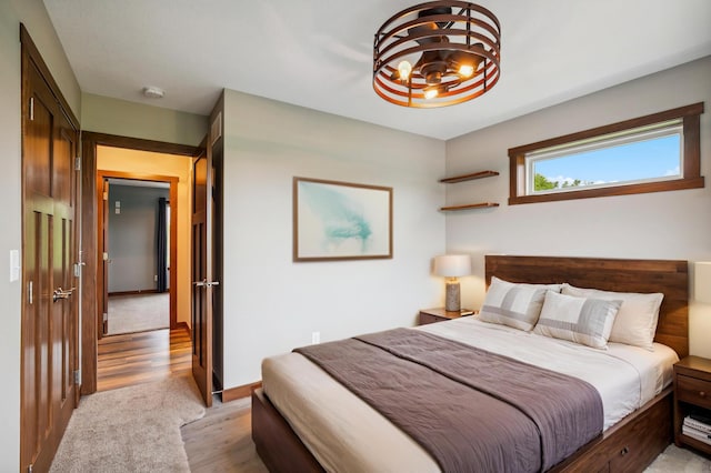 26884 709th St, Lake City, MN 55041 - bedroom with light wood-type flooring and a chandelier