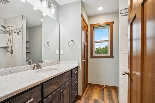 26884 709th St, Lake City, MN 55041 - bathroom featuring vanity, wood finished floors, and tiled shower