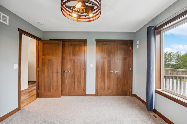 26884 709th St, Lake City, MN 55041 - unfurnished bedroom with carpet floors and two closets
