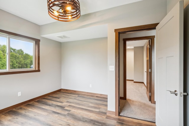 26884 709th St, Lake City, MN 55041 - spare room featuring wood finished floors and a chandelier
