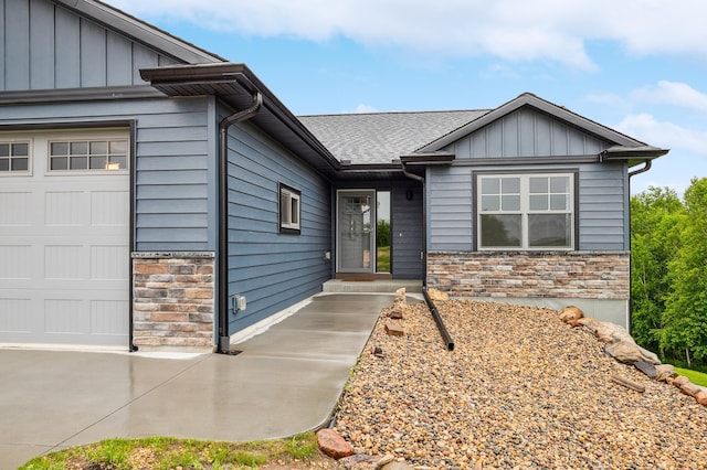 26884 709th St, Lake City, MN 55041 - view of front facade featuring stone siding, a garage, and board and batten siding