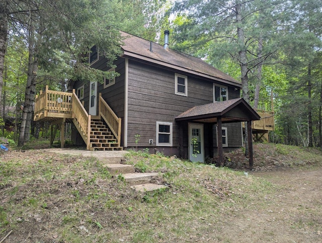 24863 Norway Pine Pl, Ross Lake Twp, MN 56447 - rear view of house with stairway, a deck, and roof with shingles