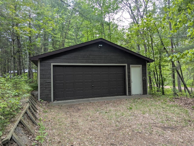 24863 Norway Pine Pl, Ross Lake Twp, MN 56447 - detached garage featuring a view of trees