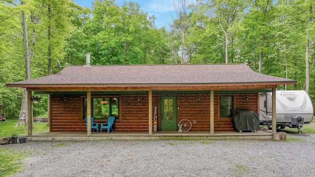 W8567 County Road Mm, Mead Twp, WI 54437 - chalet / cabin with a shingled roof, a porch, and log veneer siding
