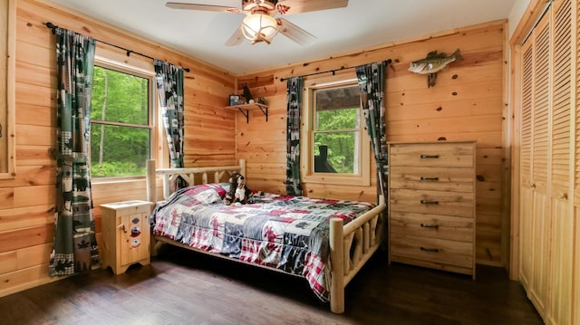 W8567 County Road Mm, Mead Twp, WI 54437 - bedroom with dark wood-style floors, multiple windows, wood walls, and a ceiling fan