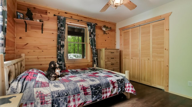 W8567 County Road Mm, Mead Twp, WI 54437 - bedroom with dark wood finished floors, a closet, a ceiling fan, and wooden walls