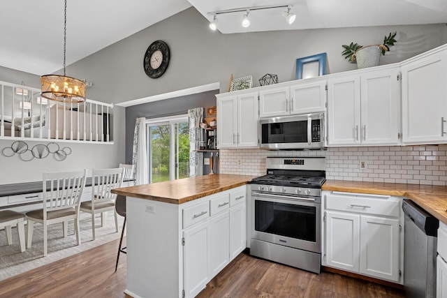 903 6th Ave NW, Buffalo, MN 55313 - kitchen featuring appliances with stainless steel finishes, butcher block countertops, a peninsula, white cabinets, and lofted ceiling