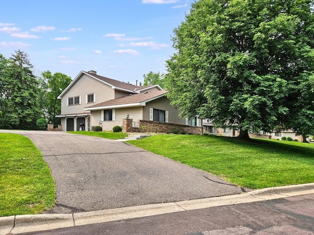 7635 Wedgewood Ct N, Maple Grove, MN 55311 - view of front facade with a garage, a front lawn, and driveway