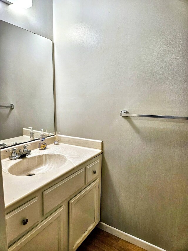 7635 Wedgewood Ct N, Maple Grove, MN 55311 - bathroom featuring vanity, wood finished floors, and baseboards
