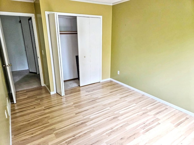 7635 Wedgewood Ct N, Maple Grove, MN 55311 - unfurnished bedroom with baseboards, a closet, wood finished floors, and ornamental molding