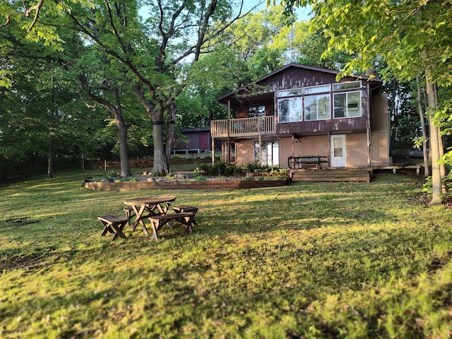 12183 Crooked Lake Ln SW, Moe Twp, MN 56327 - rear view of house featuring a deck, a yard, and view of wooded area