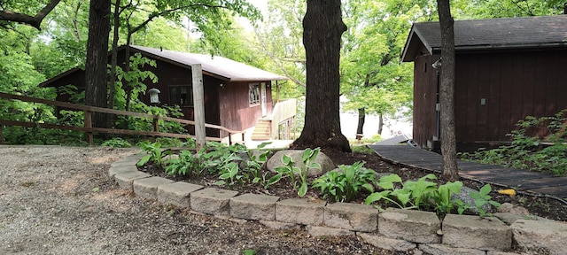 12183 Crooked Lake Ln SW, Moe Twp, MN 56327 - view of property exterior with a wooded view