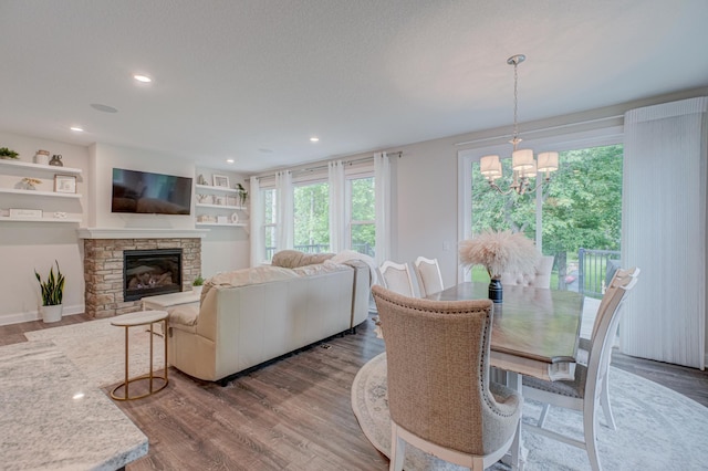 1345 Bluff Border Rd, New Richmond, WI 54017 - living room featuring wood finished floors, a chandelier, a fireplace, and recessed lighting