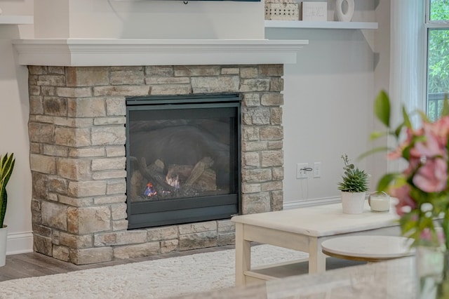 1345 Bluff Border Rd, New Richmond, WI 54017 - detailed view of wood finished floors, baseboards, and a fireplace
