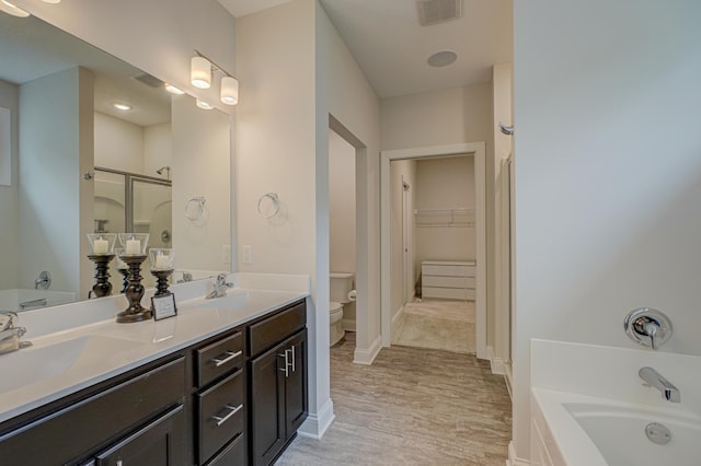 1345 Bluff Border Rd, New Richmond, WI 54017 - full bathroom with toilet, a garden tub, a shower stall, double vanity, and a spacious closet