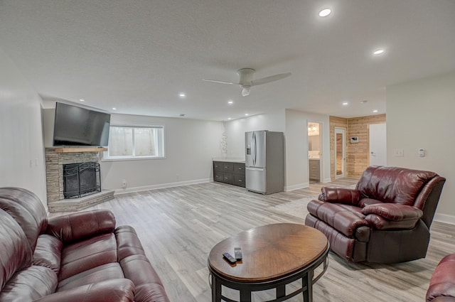 1345 Bluff Border Rd, New Richmond, WI 54017 - living area with light wood finished floors, baseboards, a ceiling fan, recessed lighting, and a stone fireplace