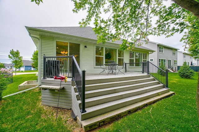 1345 Bluff Border Rd, New Richmond, WI 54017 - back of property with a wooden deck, a lawn, and a shingled roof