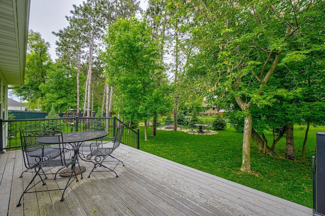 1345 Bluff Border Rd, New Richmond, WI 54017 - deck featuring outdoor dining area and a lawn