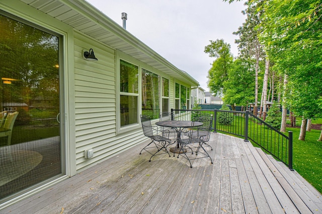 1345 Bluff Border Rd, New Richmond, WI 54017 - deck with outdoor dining area and a yard