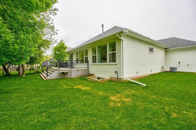 1345 Bluff Border Rd, New Richmond, WI 54017 - view of property exterior with a deck, a lawn, central AC unit, and roof with shingles
