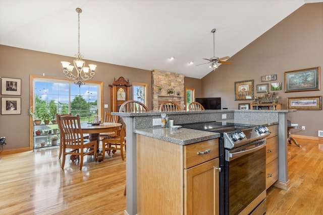 26033 607th St, Mantorville, MN 55955 - kitchen with stainless steel range with electric stovetop, light wood-style flooring, a chandelier, ceiling fan, and decorative light fixtures