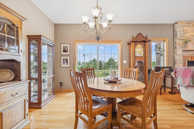 26033 607th St, Mantorville, MN 55955 - dining room with a fireplace, healthy amount of natural light, light wood-type flooring, and a chandelier