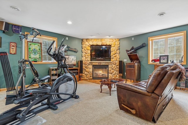 26033 607th St, Mantorville, MN 55955 - exercise room featuring a stone fireplace, carpet flooring, and recessed lighting